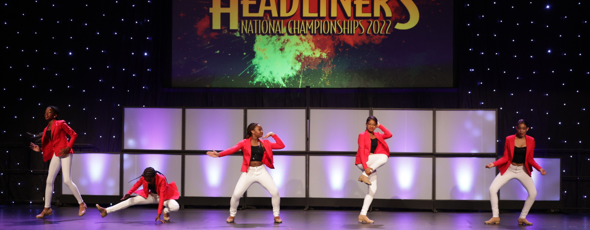 A group of tap dancers performing on stage.