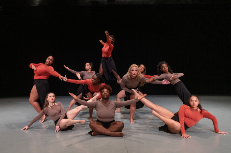 A group of dancers posing on a stage.