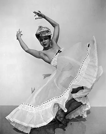 A black and white photo of a woman dancing in a dress.